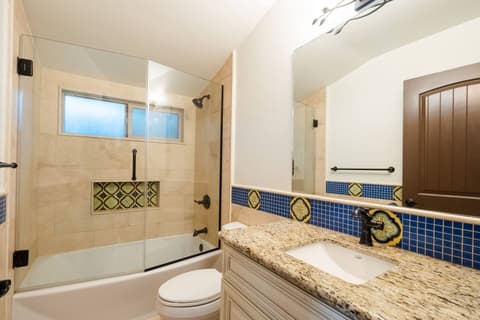 Vibrantly decorated bathroom with a luxurious hot tub, creating the ideal blend for a delightful experience.