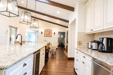 Beautiful contemporary kitchen, fully equipped with a refrigerator and oven for preparing delicious meals during your stay.