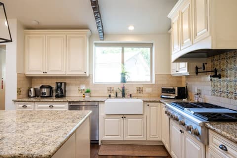 Gorgeous modern kitchen, fully stocked with a fridge and oven for crafting delectable meals throughout your visit.