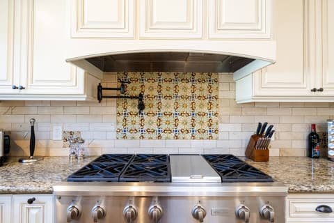 Stunning and well-appointed kitchen, fully stocked with a modern refrigerator and oven to elevate your culinary experience during your stay.