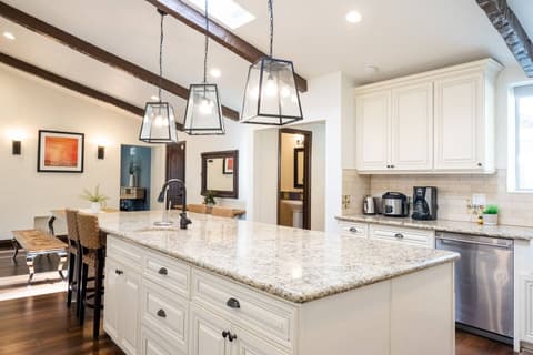 Gorgeous modern kitchen, fully stocked with a fridge and oven for crafting delectable meals throughout your visit.