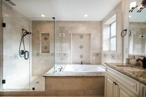 Spacious bathroom featuring a luxurious soaking tub and fantastic natural lighting.