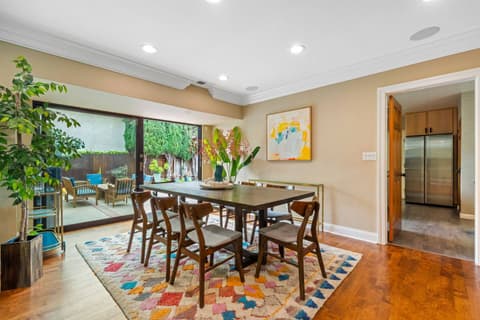 Spacious dining area w/ a large table for family meals and gatherings. An additional round table w/ 4 seats provides extra dining space. Bright and inviting, ideal for creating memorable moments together.