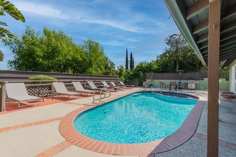 Warm swimming pool with inviting lounging areas for your pleasure.
