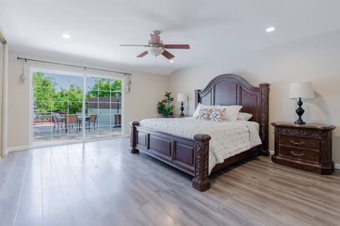 A spacious and sun-filled bedroom, featuring a comfortable double bed, and offering stunning external views.