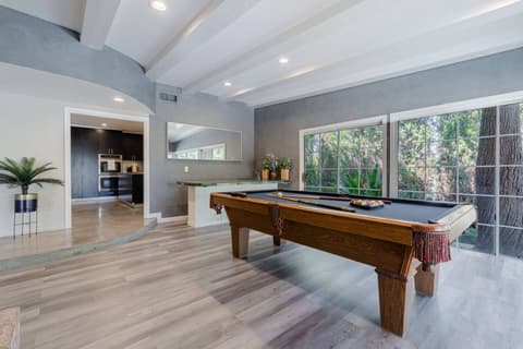 Generously sized living area perfect for entertaining with billiards or cozying up to the fireplace for warmth.