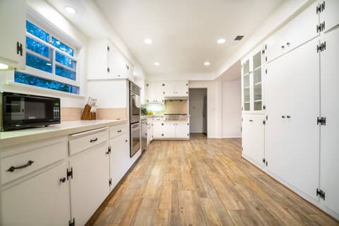 Gorgeous modern kitchen, fully stocked with a fridge and oven for crafting delectable meals throughout your visit.