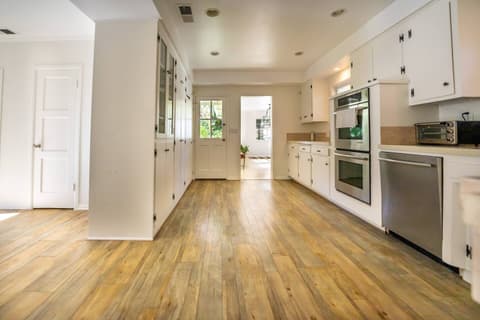 Stunning modern kitchen, equipped with top-of-the-line appliances such as a fridge and oven, perfect for crafting delectable meals throughout your visit.