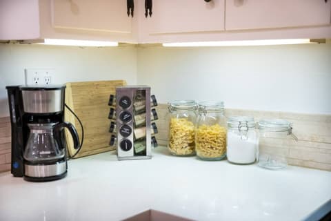 Stunning modern kitchen, equipped with top-of-the-line appliances such as a fridge and oven, perfect for crafting delectable meals throughout your visit.