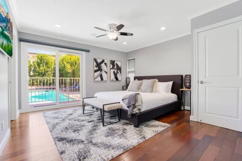 Master bedroom with a king-size bed, fireplace, and en-suite bathroom.