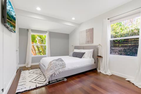 An expansive and lavish suite with a queen-size bed and exceptional natural light.