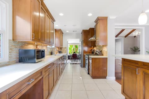 An upscale and fully-equipped kitchen with state-of-the-art appliances, meticulously crafted to enhance your culinary experience and create outstanding meals.