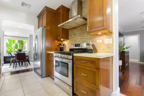 An upscale and fully-equipped kitchen with state-of-the-art appliances, meticulously crafted to enhance your culinary experience and create outstanding meals