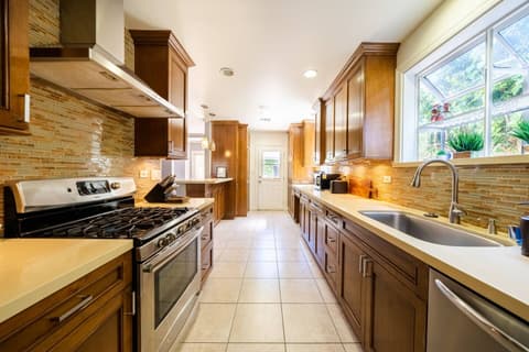 Gorgeous modern kitchen, fully stocked with a fridge and oven for crafting delectable meals throughout your visit.