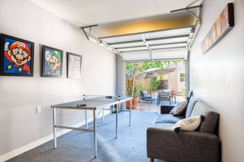 Expansive recreational space equipped with a ping pong table and an assortment of entertaining games.