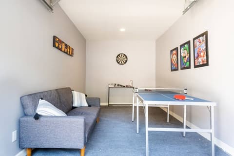 Generous game room featuring a ping pong table and various entertaining activities.