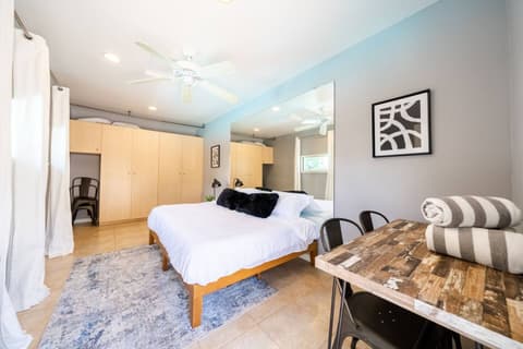 Generous bedroom drenched in natural light, featuring a cozy double bed, breathtaking outdoor vistas, and a full range of amenities for an utterly rejuvenating experience.